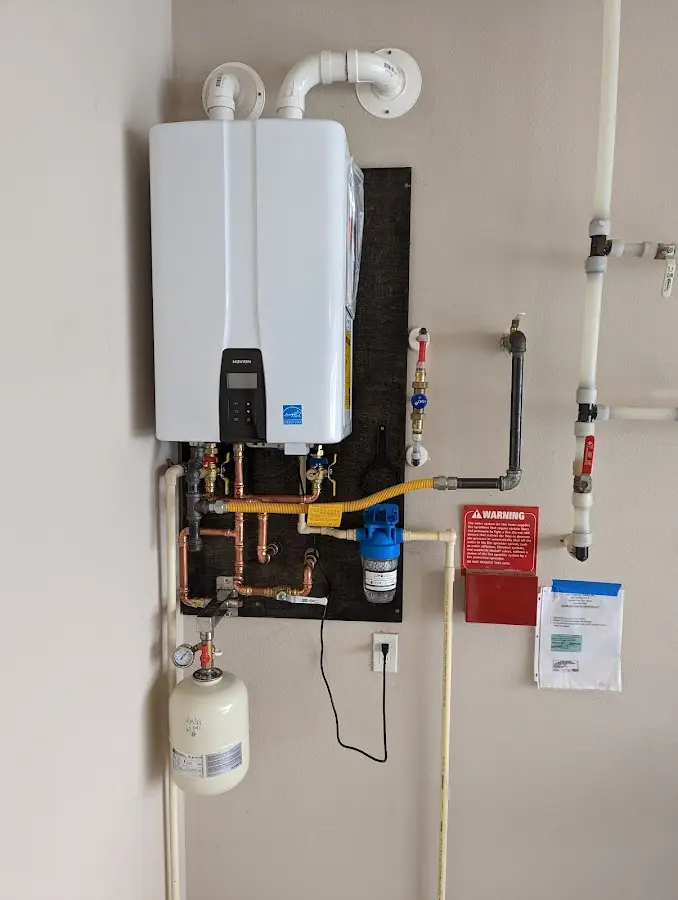 Professional plumber installing copper piping in a Pico Rivera home